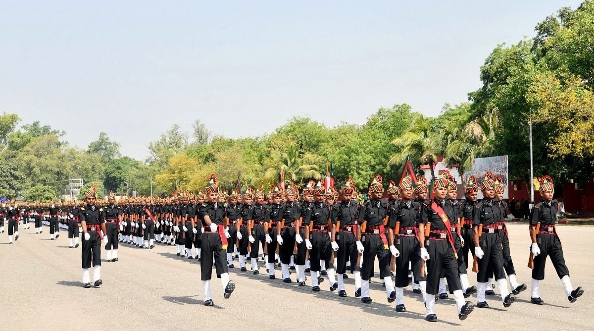 Two young cadets in uniform standing in front of a large governmental building with sky background