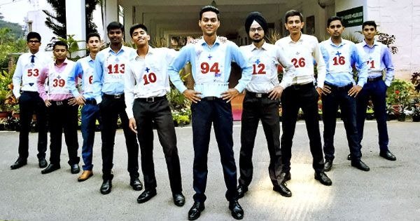Young man wearing white vest with red cross standing confidently for SSB Interview coaching